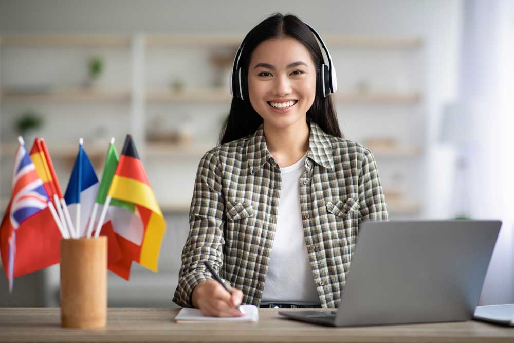 academic english student studying at laptop