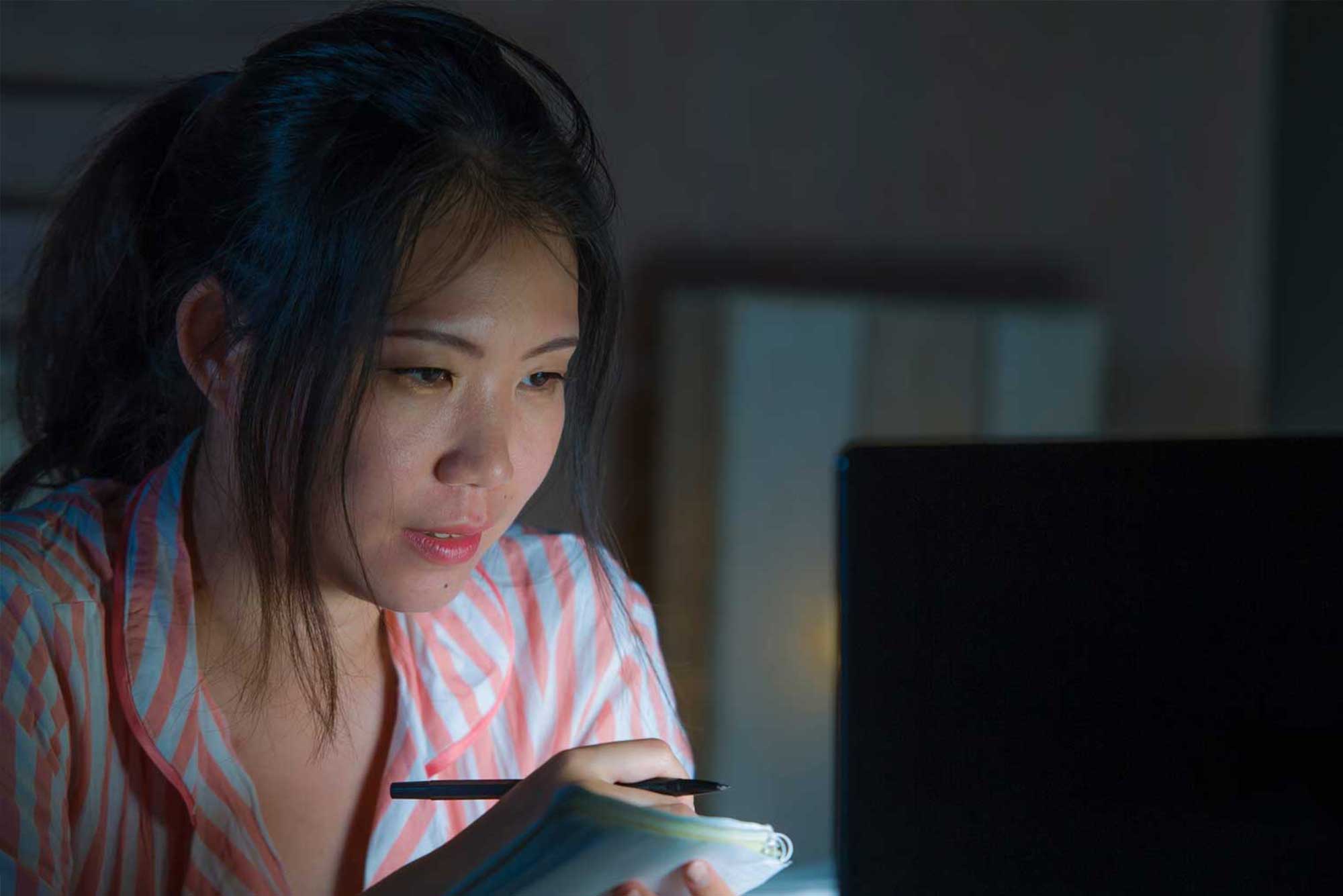 student studying late on computer