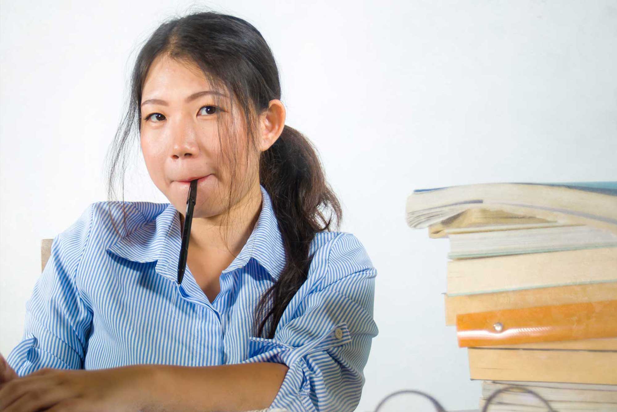 global student making notes on a laptop